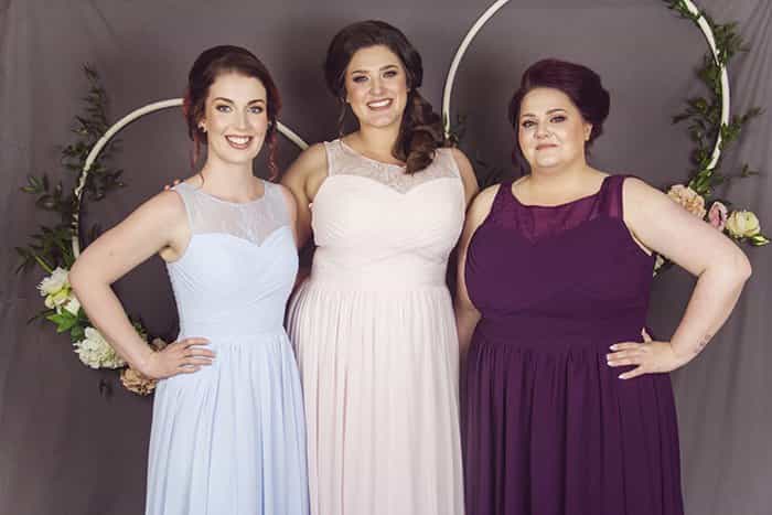 Curvy bridesmaids wearing Kiri dresses in blue, pink and grape
