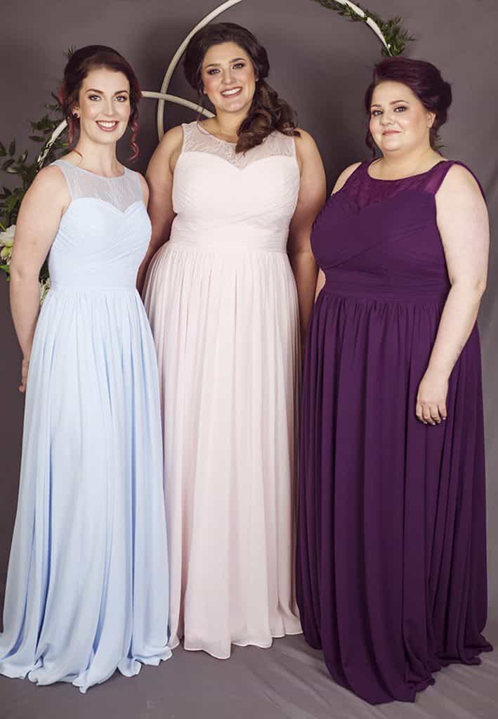 Curvy bridesmaids wearing Kiri dresses in blue, pink and grape