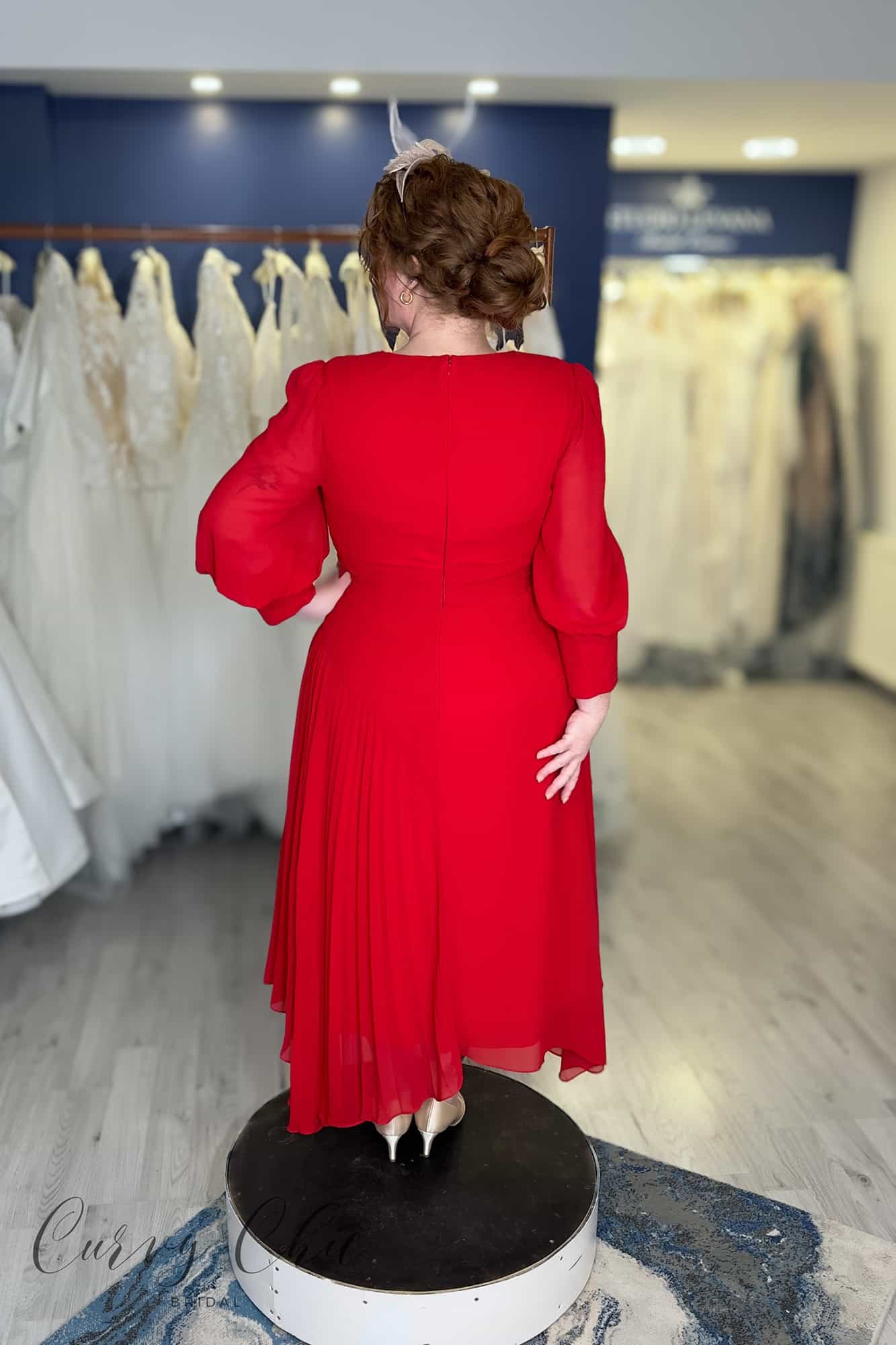 Back view of red Veni Infantino chiffon dress showing bishop sleeves and asymmetric pleated high-low hemline, plus size occasion wear Belfast