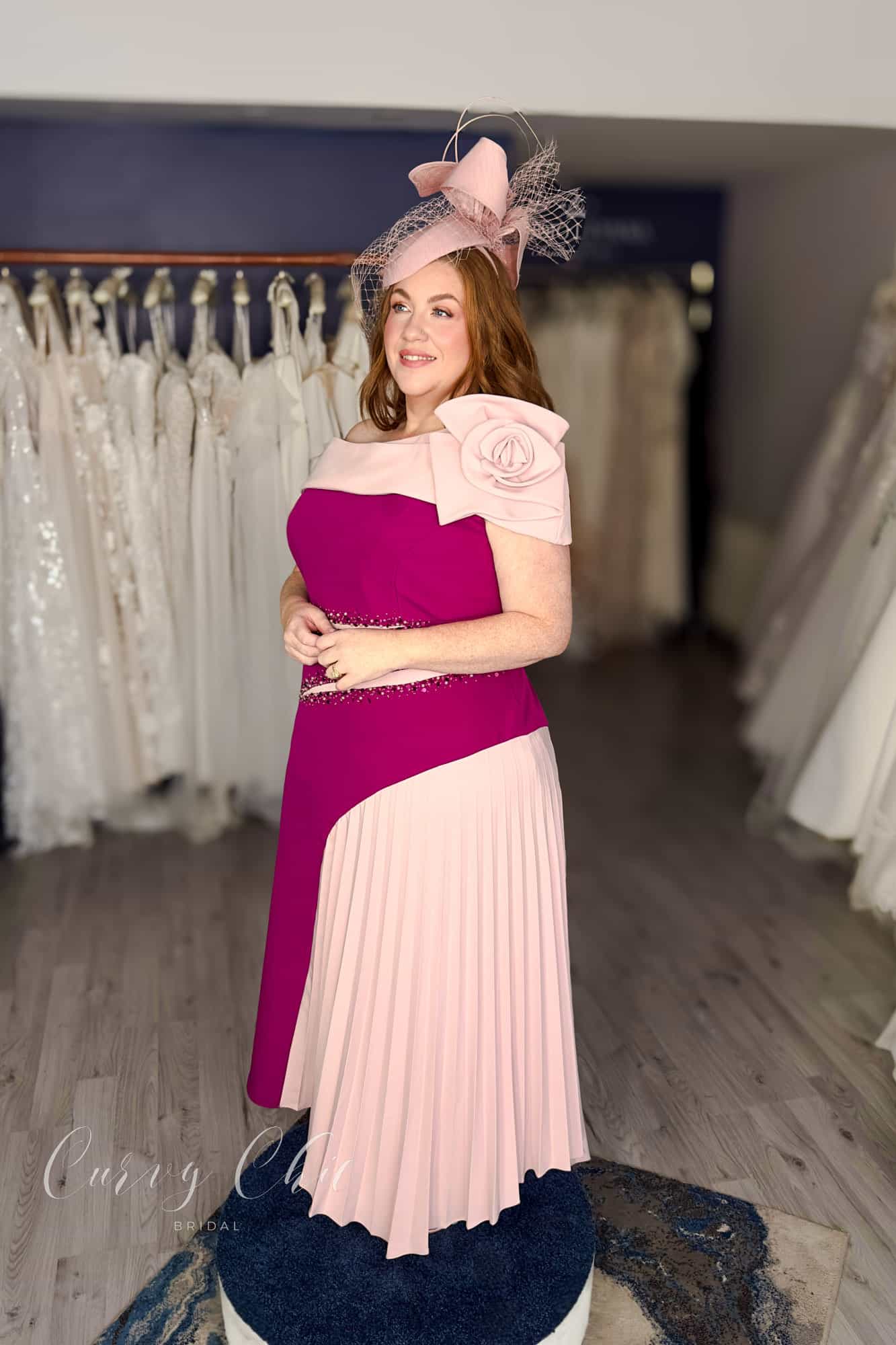 Berry and blush plus size occasion dress with beaded waist detail and asymmetric pleated skirt, side view, Curvy Chic Boutique