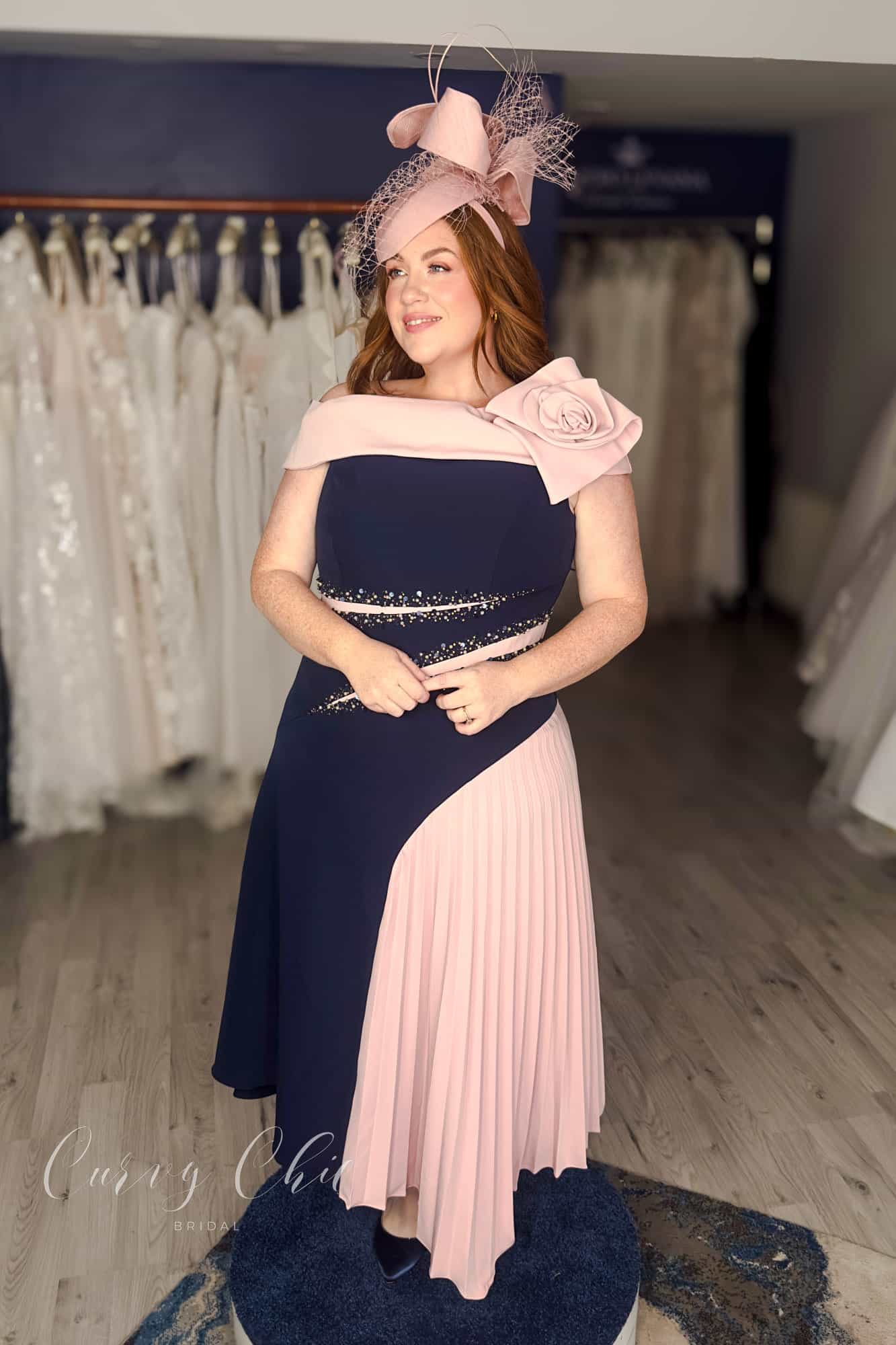 Navy and blush plus size occasion dress with beaded waist detail and asymmetric pleated skirt, Curvy Chic Boutique